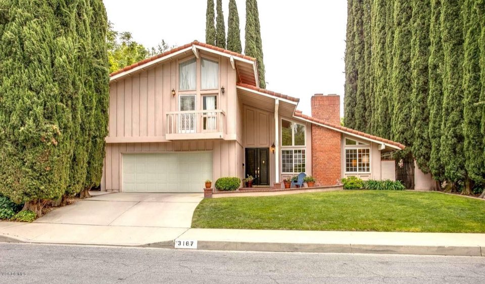 Home framed by cypress trees in Westlake Village
